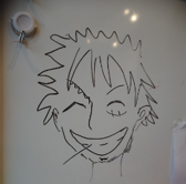 ミルトス・テントグル選手が描いた、左目の下に傷がある男の人のイラストの写真