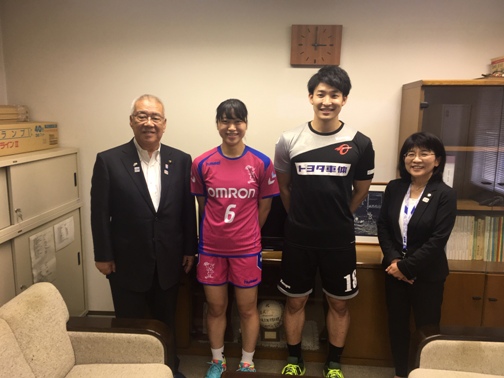 ソファが設置された室内で、石井選手と吉野選手を中央に女性と市長が横一列に並んでいる写真
